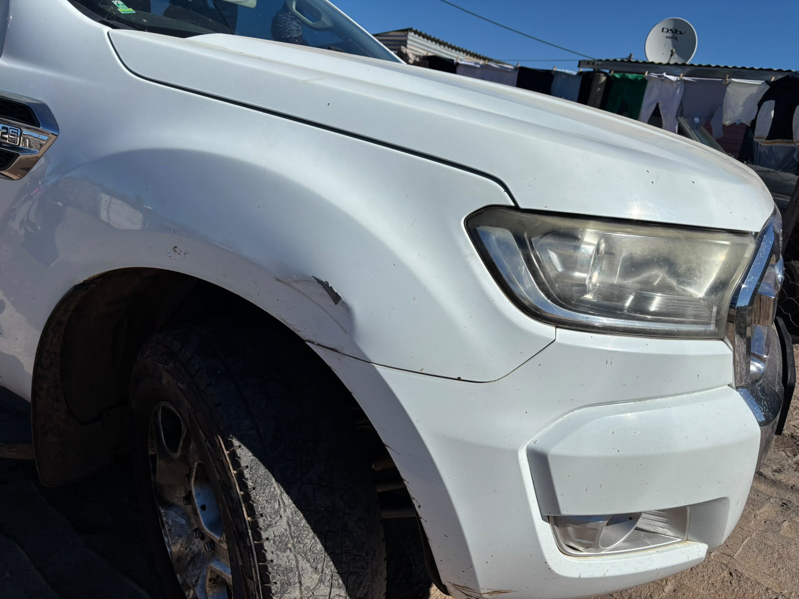White Ford Ranger front fender with scrape damage